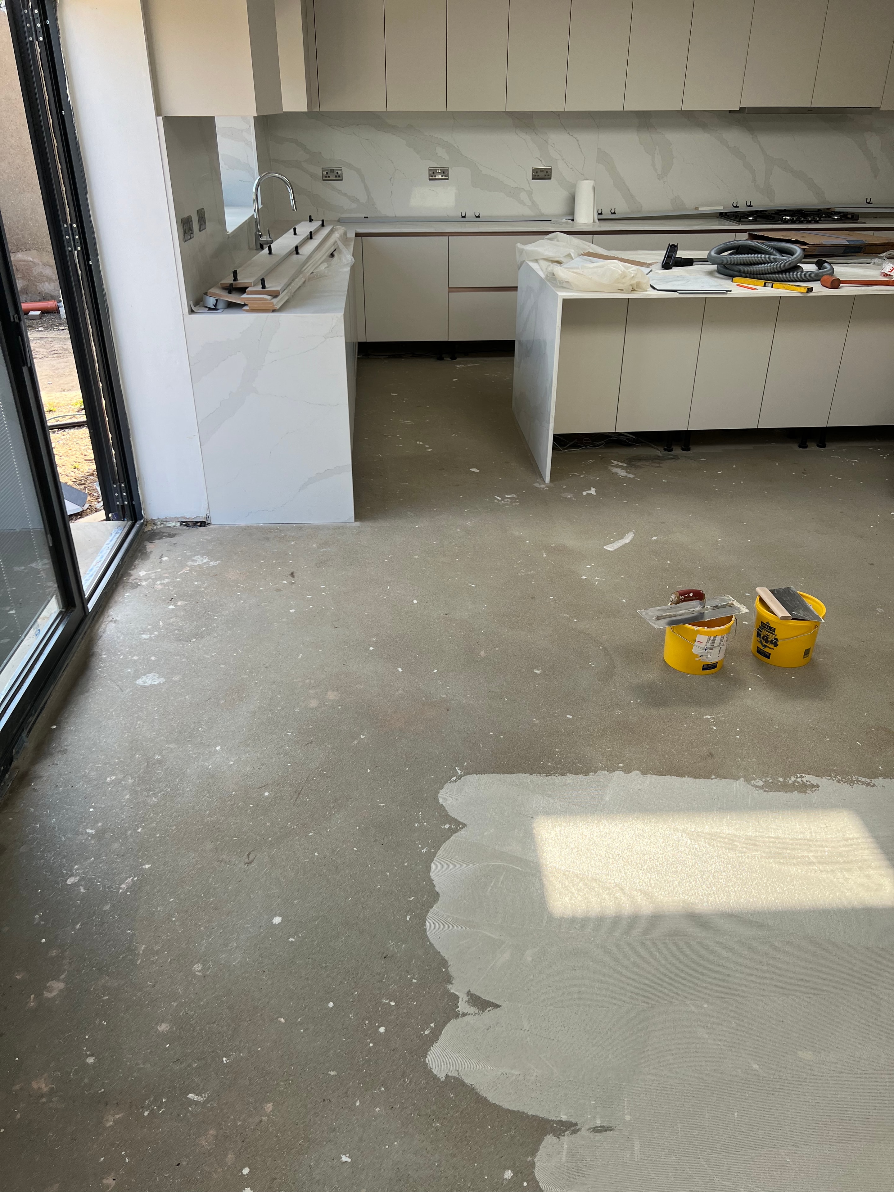 Bathroom before renovation — stripped walls, tiles removed and debris cleared