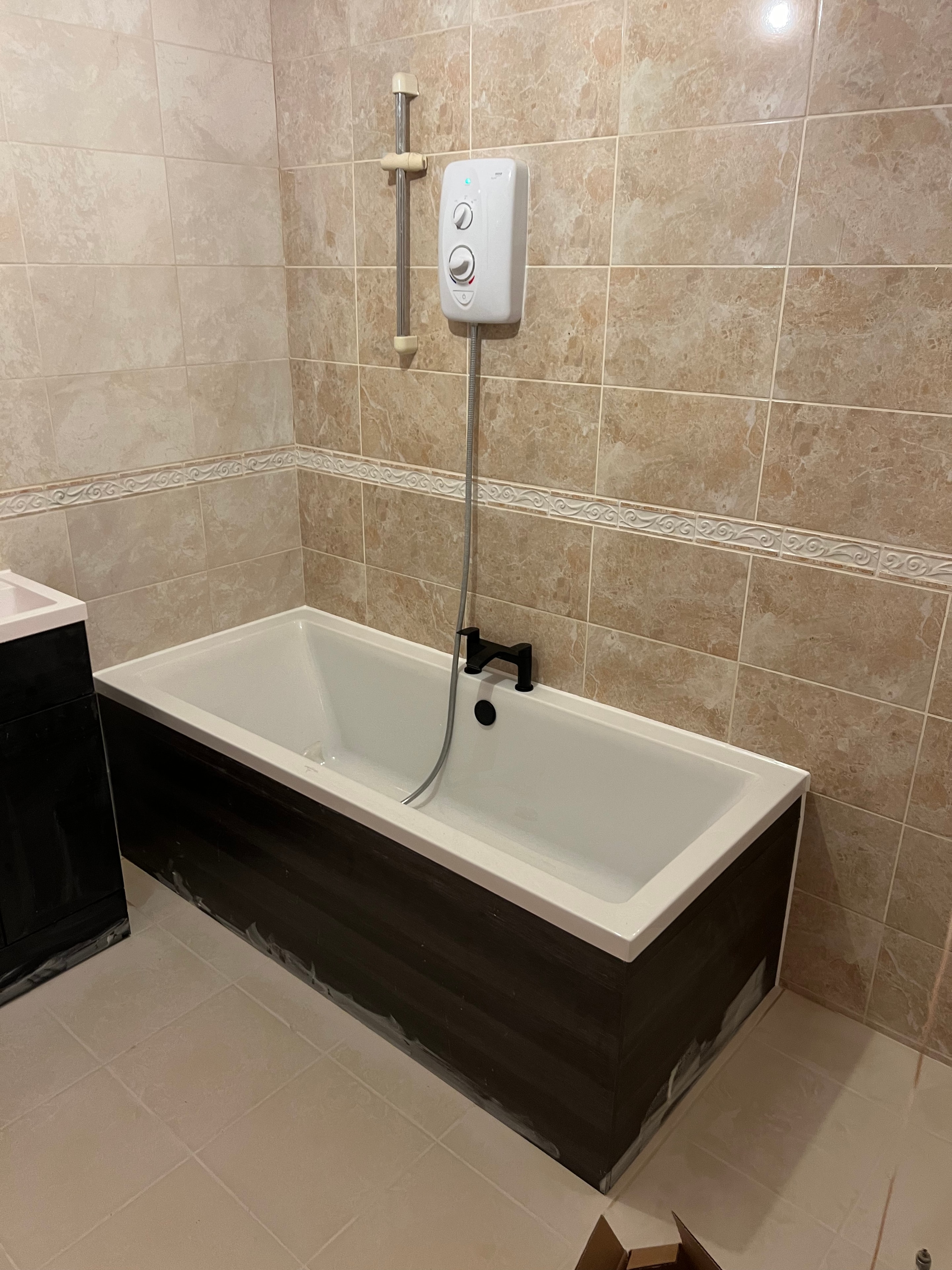 Bathroom before renovation — second angle showing old beige tiles and dated fittings