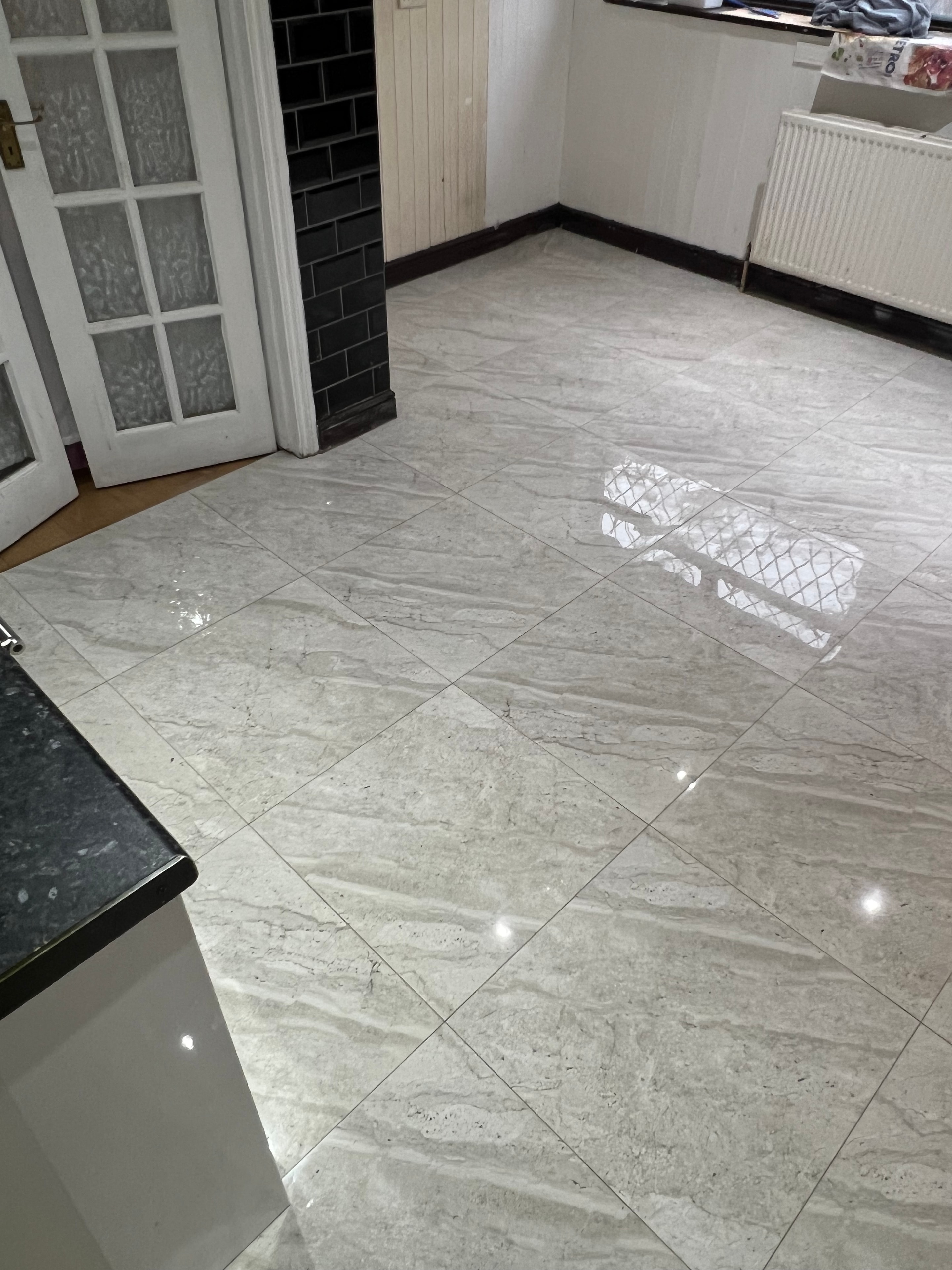 Completed tiling works — diagonal marble-effect floor tiles with polished finish
